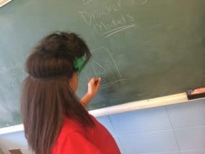 Ashanta gives examples of models on the board