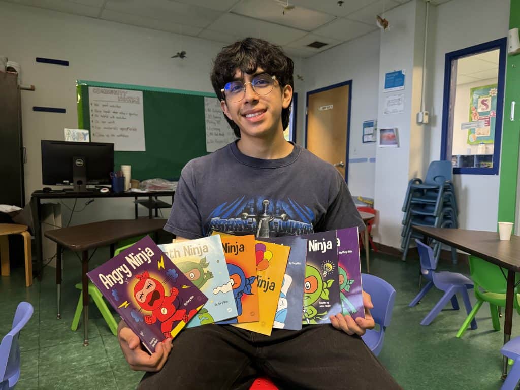 Juarez spreads a stack of children's books. One is called Angry Ninja.