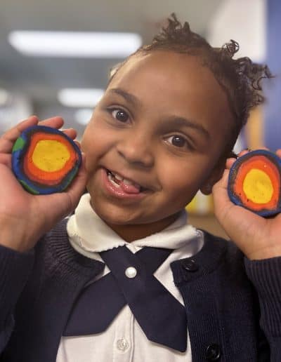girl holding clay globe