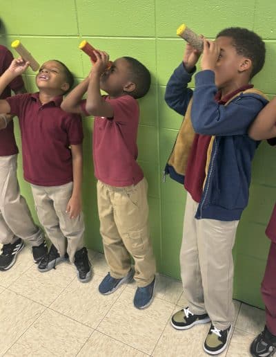 boys looking through scopes