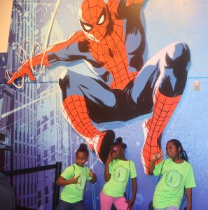 girls in front of Spiderman mural