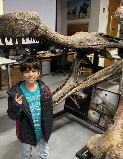 boy with dinosaur bones